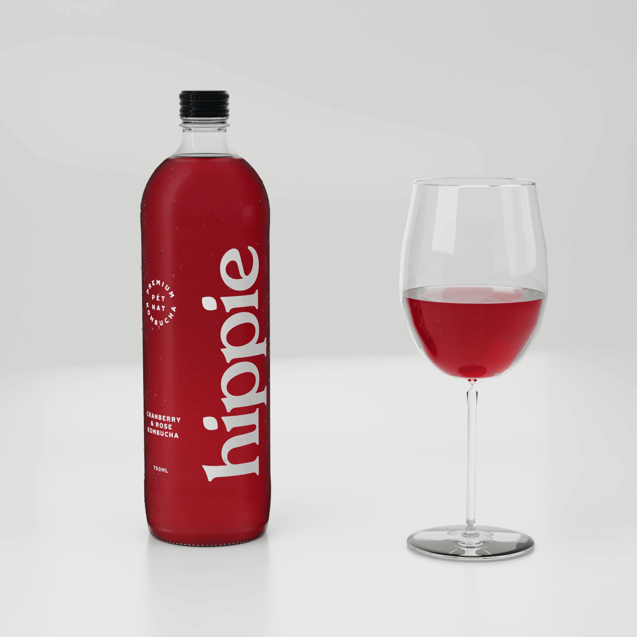 Hippie Cranberry & Rose kombucha 750ml bottle with a glass poured