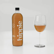 Hippie Creamy Strawberry kombucha 750ml bottle with a glass poured