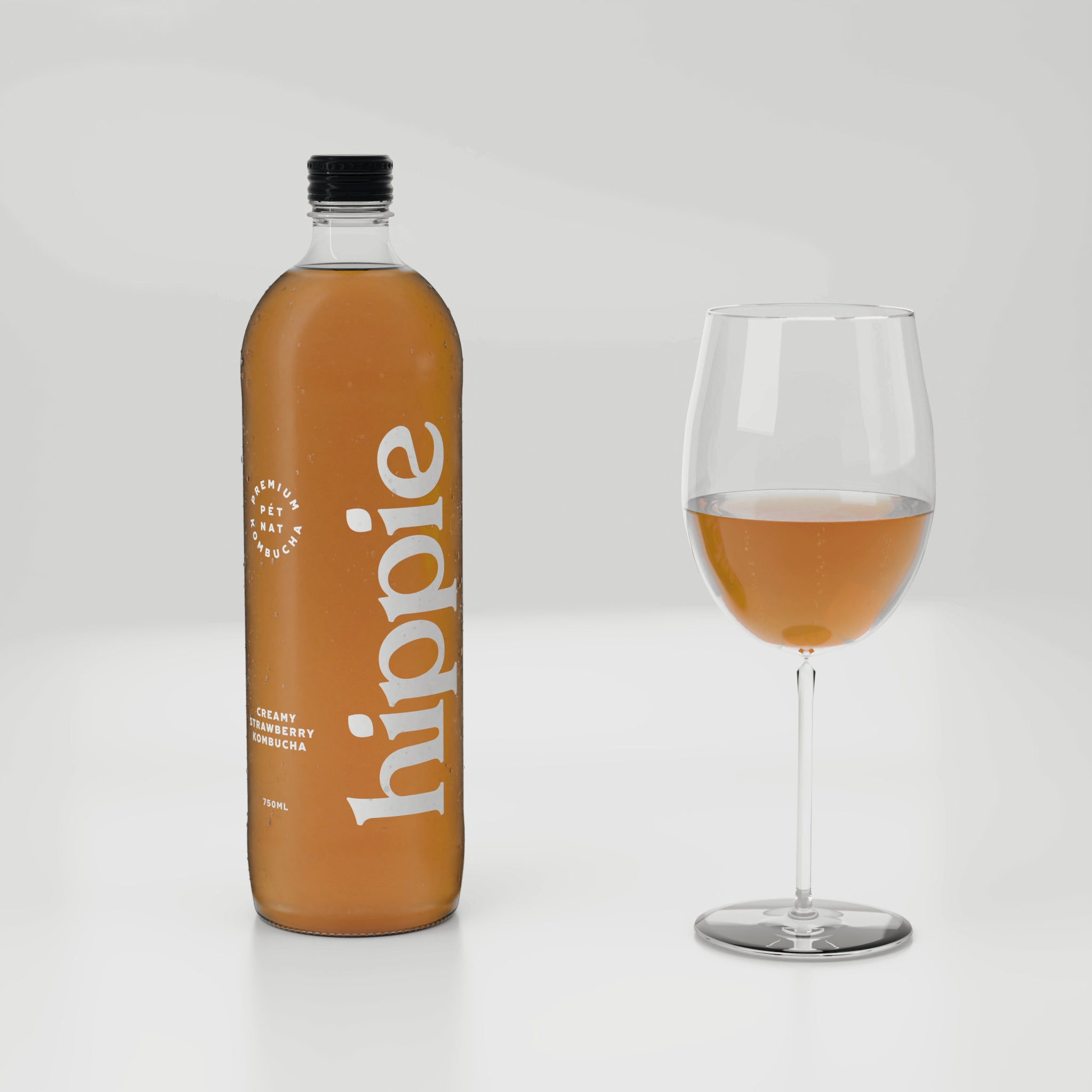Hippie Creamy Strawberry kombucha 750ml bottle with a glass poured