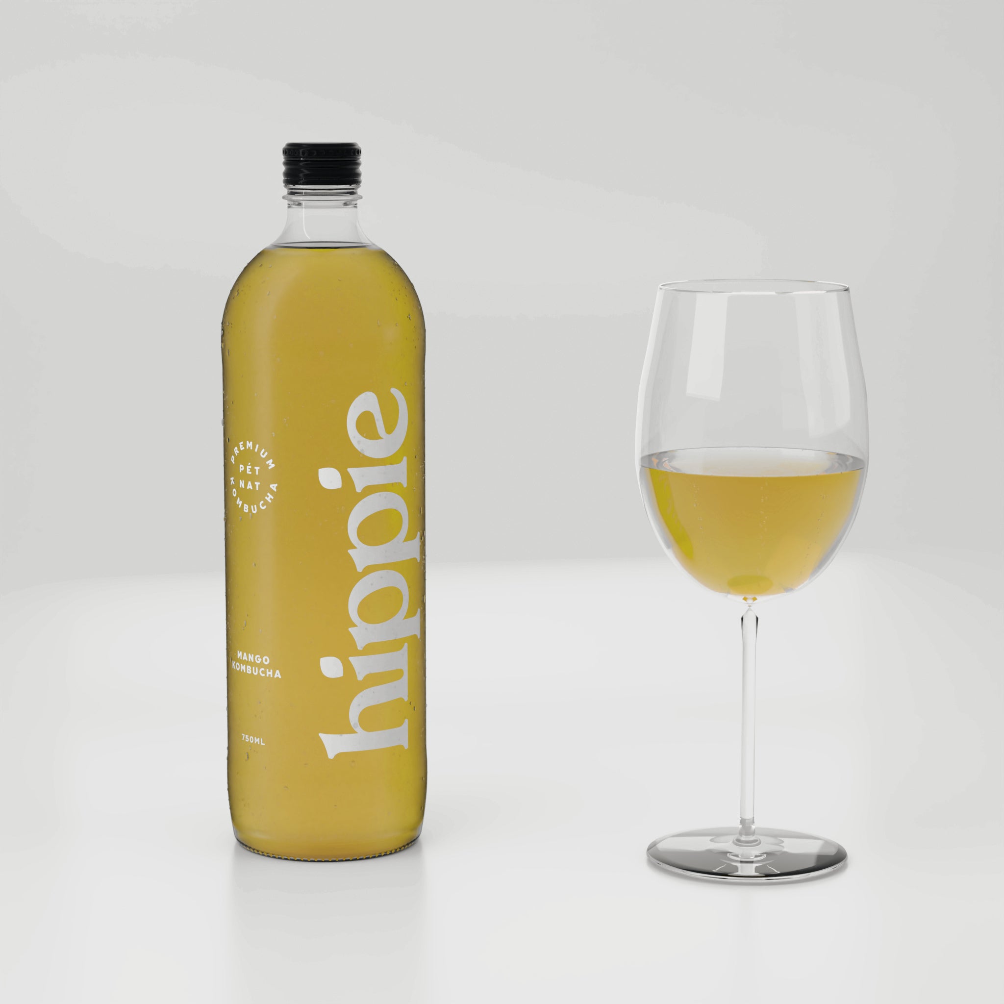 Hippie Mango kombucha 750ml bottle with a glass poured